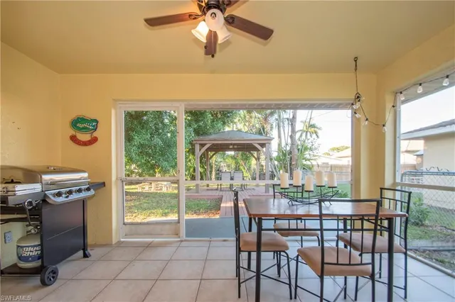 a dining room with furniture and a floor to ceiling window