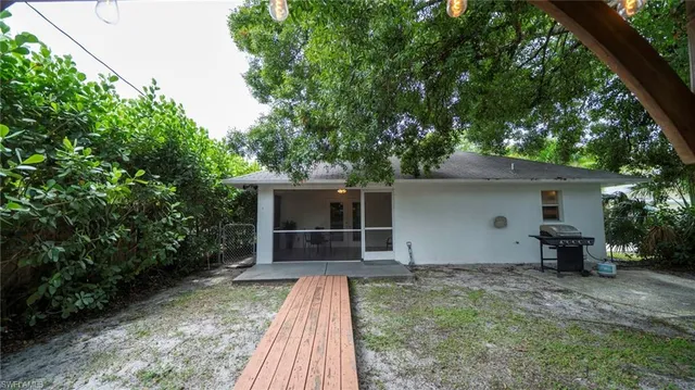 front view of a house with a yard and an outdoor seating