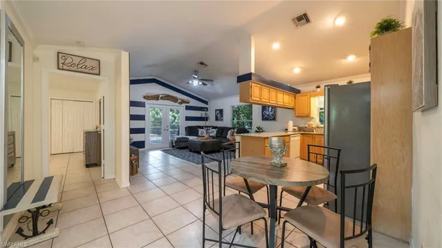 a kitchen with stainless steel appliances kitchen island granite countertop a refrigerator and cabinets