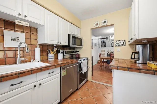 a kitchen with stainless steel appliances granite countertop a stove and a sink