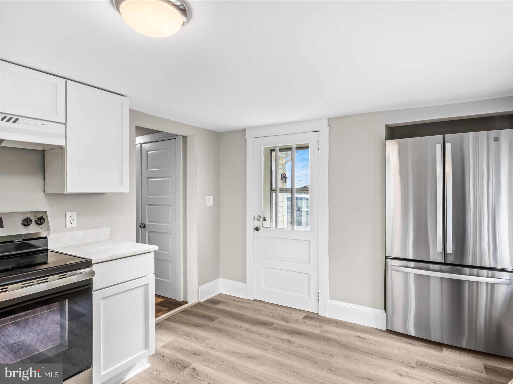 298 Bufflick Road Winchester, VA 22602 - Photo 12 of 38 a kitchen with a refrigerator stove and wooden floor