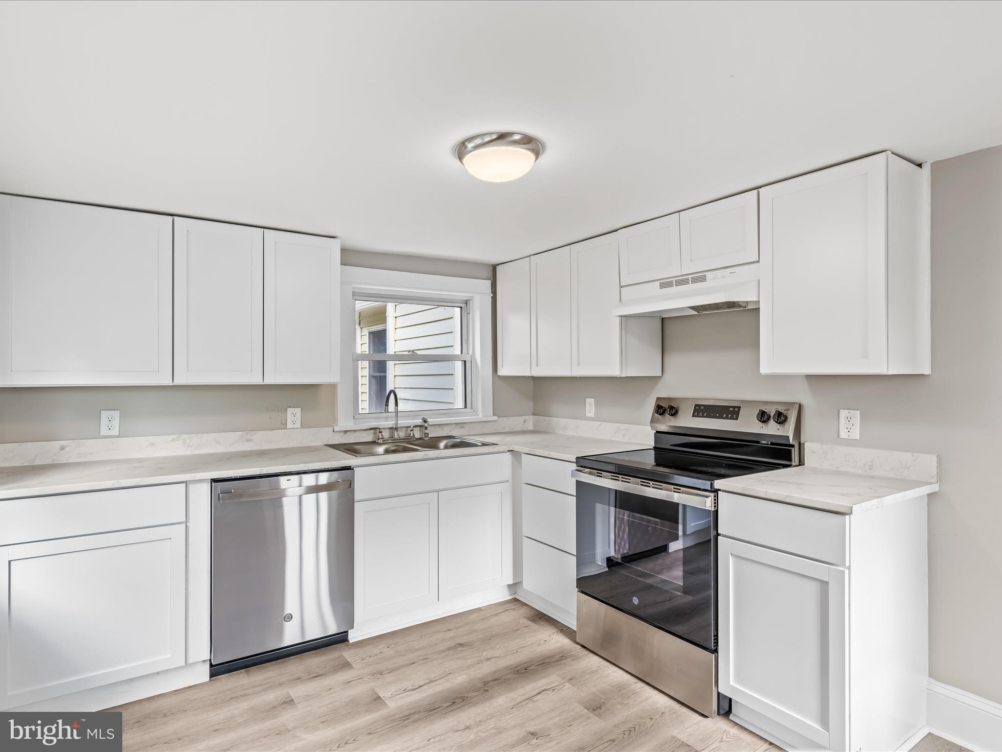 298 Bufflick Road Winchester, VA 22602 - Photo 4 of 38 a kitchen with white cabinets stainless steel appliances and sink