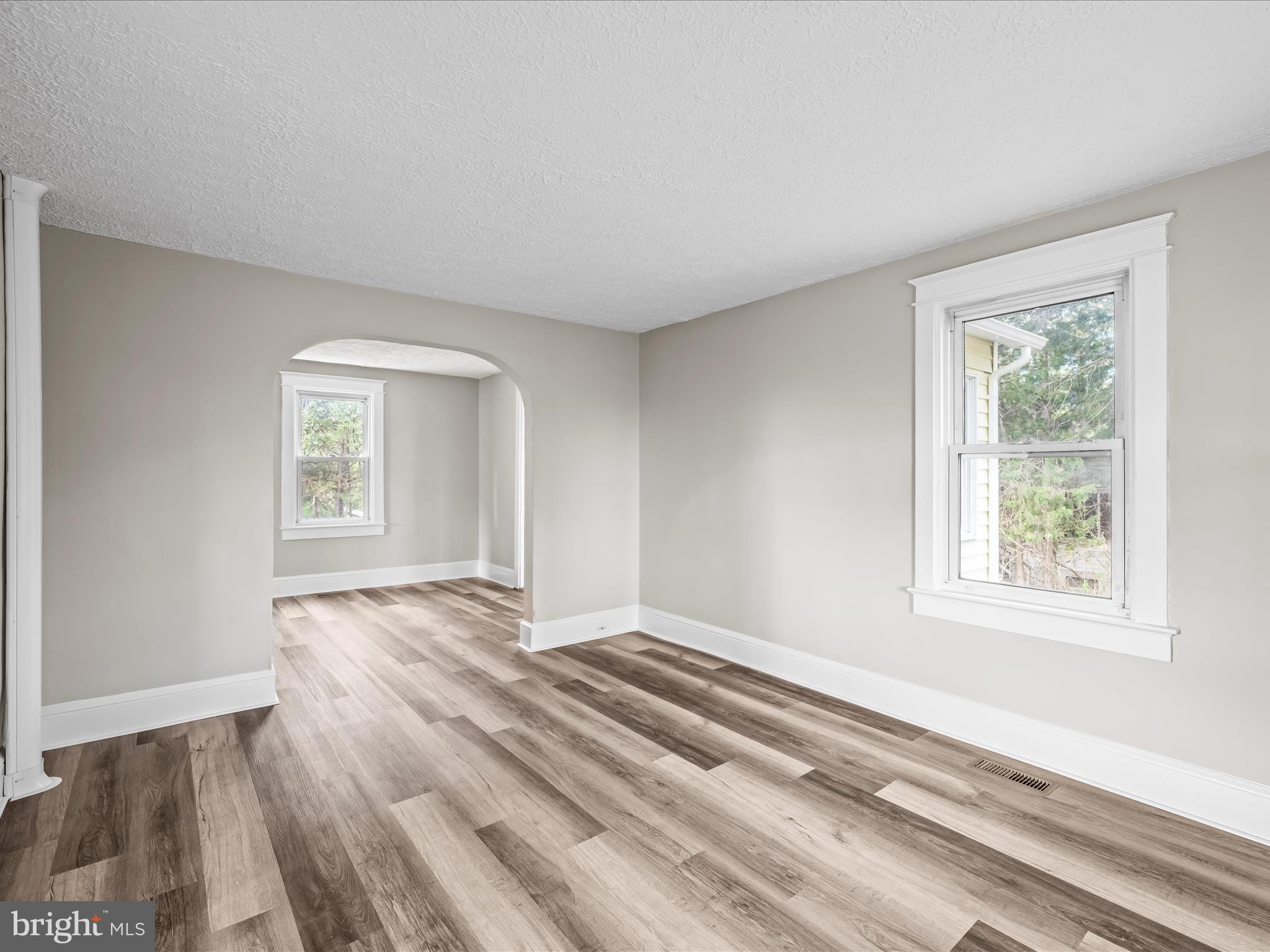 298 Bufflick Road Winchester, VA 22602 - Photo 5 of 38 a view of an empty room with wooden floor and a window