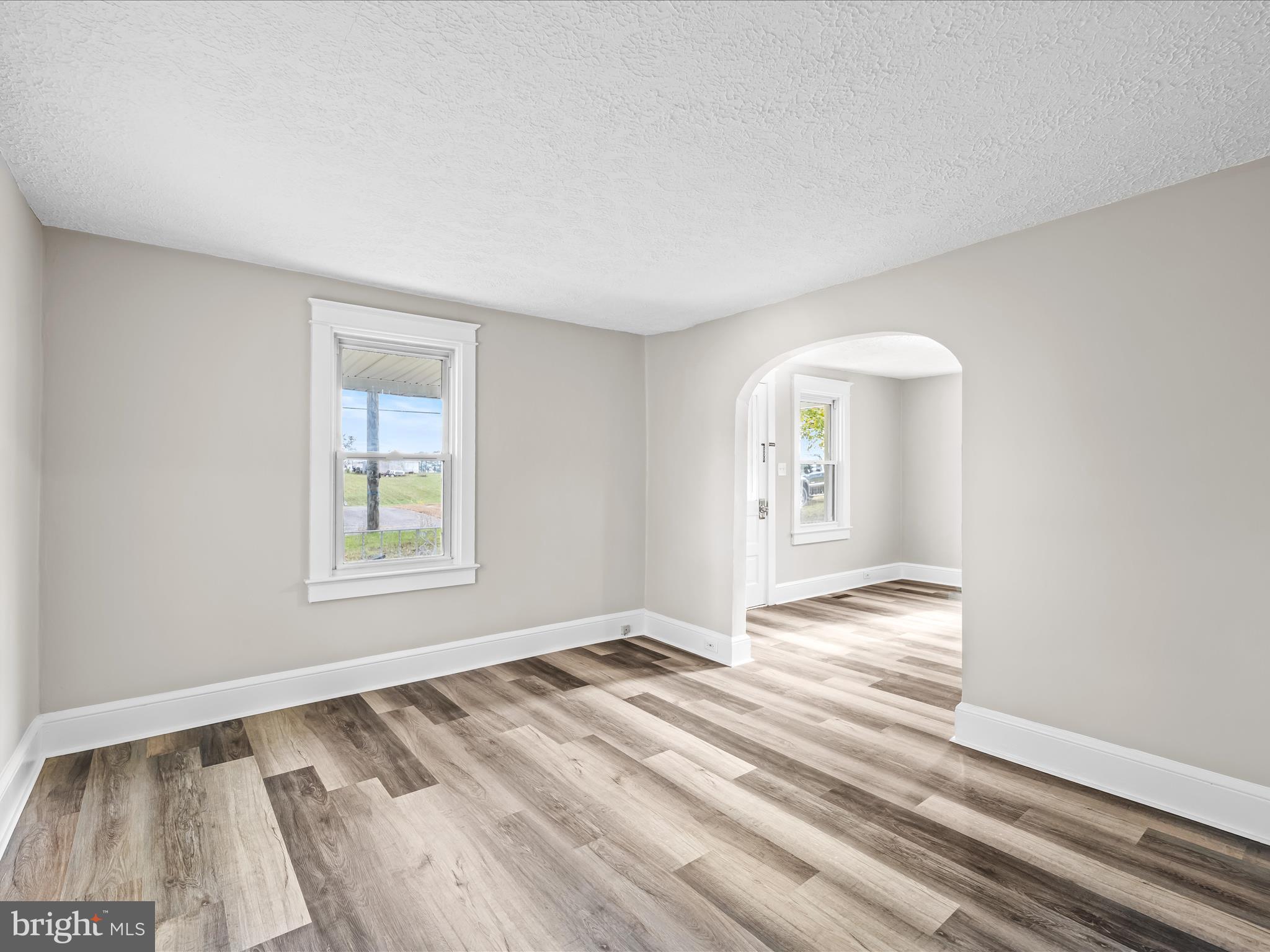 298 Bufflick Road Winchester, VA 22602 - Photo 8 of 38 a view of an empty room with wooden floor and a window