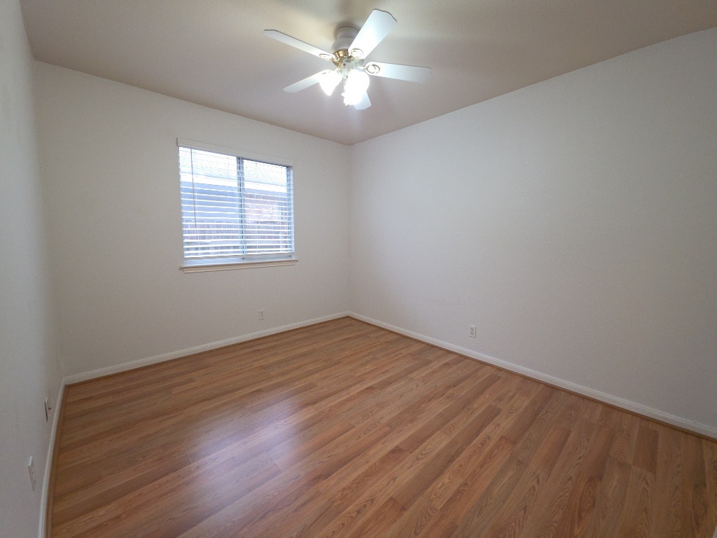 21320 Derby Day Avenue Pflugerville, TX 78660 - Photo 14 of 21 wooden floor in an empty room with a window