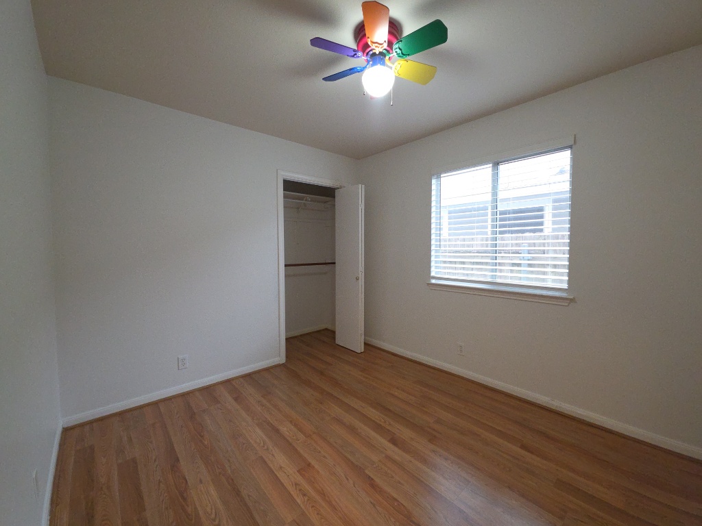 21320 Derby Day Avenue Pflugerville, TX 78660 - Photo 17 of 21 a view of an empty room with window and wooden floor