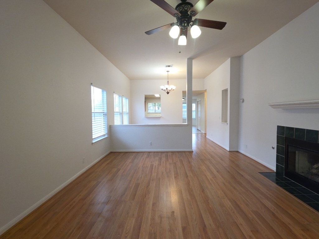 21320 Derby Day Avenue Pflugerville, TX 78660 - Photo 3 of 21 wooden floor in an empty room with a window