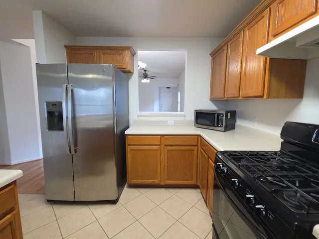 a kitchen with refrigerator and cabinets