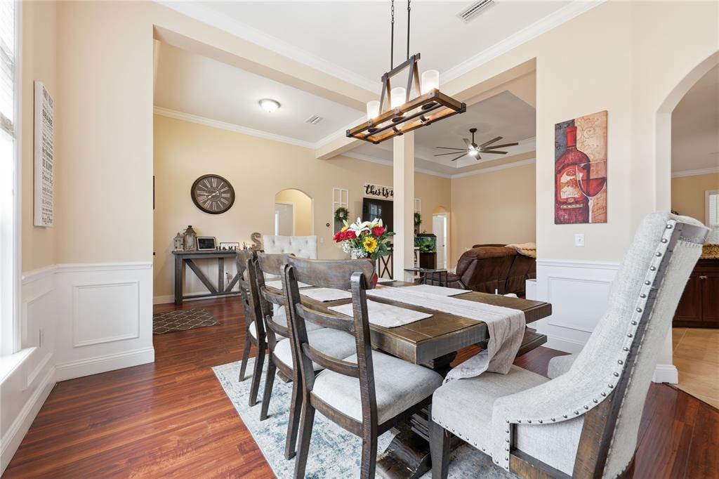 24934 Northwest 170th Road High Springs, FL 32643 - Photo 11 of 33 a view of a dining room and livingroom with furniture wooden floor a chandelier
