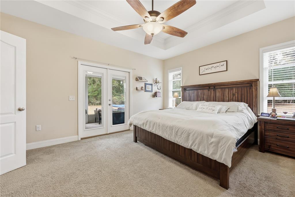 24934 Northwest 170th Road High Springs, FL 32643 - Photo 17 of 33 a spacious bedroom with a bed and a chandelier