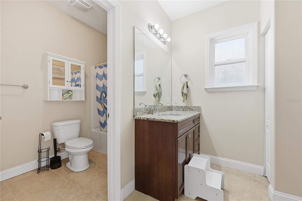 24934 Northwest 170th Road High Springs, FL 32643 - Photo 29 of 33 a bathroom with a granite countertop toilet a sink and a mirror