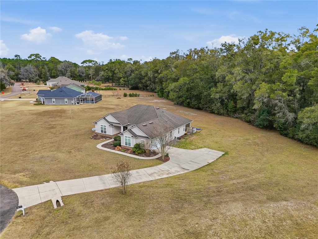 24934 Northwest 170th Road High Springs, FL 32643 - Photo 33 of 33 a view of a swimming pool and lake in the back