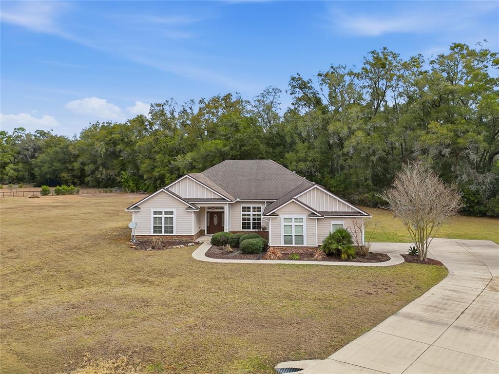 24934 Northwest 170th Road High Springs, FL 32643 - Photo 5 of 33 a front view of a house with a yard and trees