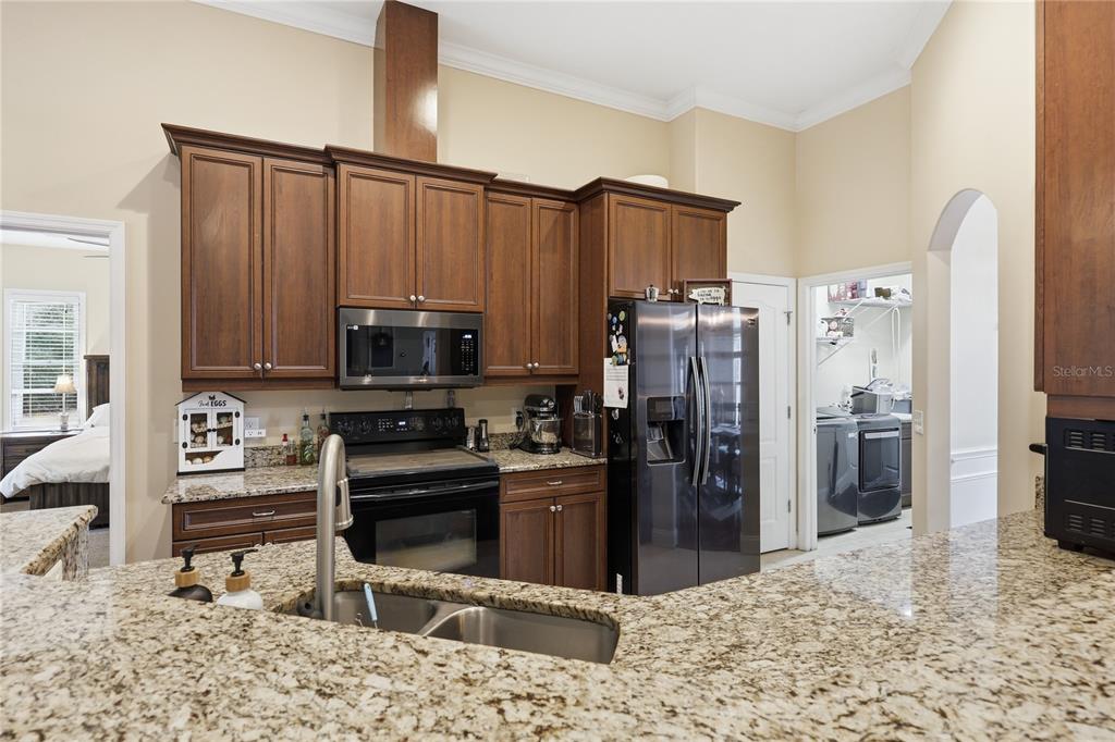 24934 Northwest 170th Road High Springs, FL 32643 - Photo 8 of 33 a kitchen with stainless steel appliances kitchen island granite countertop a refrigerator and a stove top oven