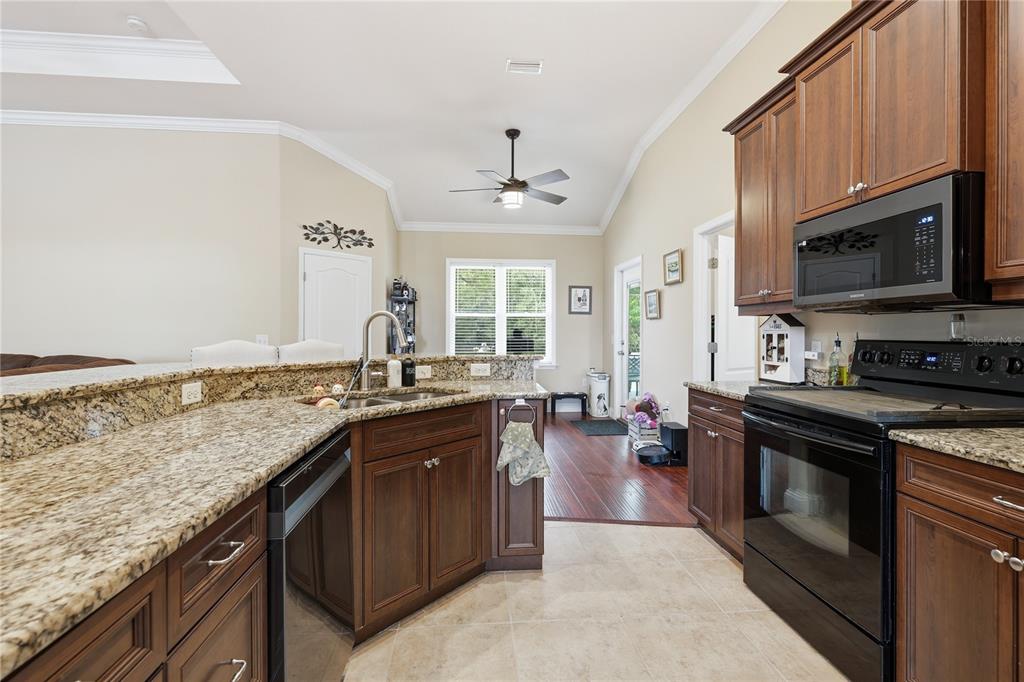 24934 Northwest 170th Road High Springs, FL 32643 - Photo 10 of 33 a kitchen with stainless steel appliances granite countertop a sink stove and oven