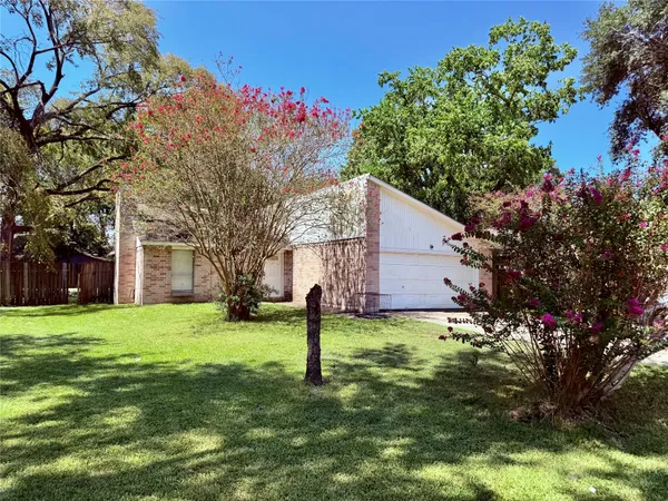 a backyard of a house with lots of green space and fountain