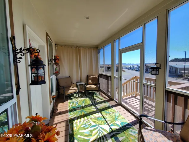 a living room with furniture a rug and a window