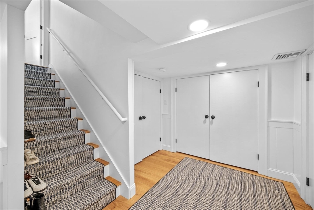 31 Franklin Street Marblehead, MA 01945 - Photo 24 of 35 a view of a hallway with wooden floor and staircase