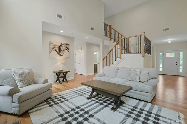 a living room with furniture and wooden floor