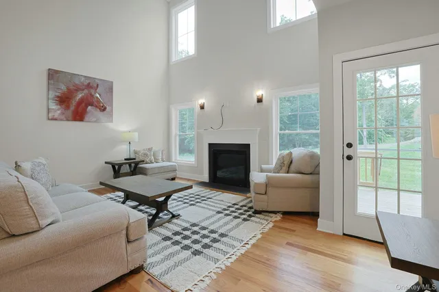 a living room with furniture a large window and a fireplace