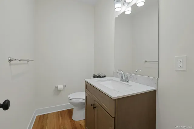 a bathroom with a sink toilet and a mirror