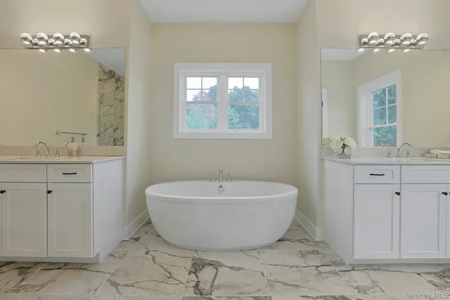 a spacious bathroom with a bathtub and shower