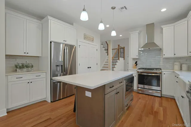 a kitchen with a stove a sink and a refrigerator
