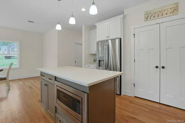 a kitchen that has a sink and a wooden floor