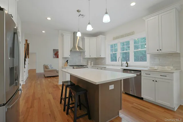 a kitchen with sink stove and refrigerator