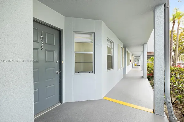 a view of a hallway with wooden floor and entryway