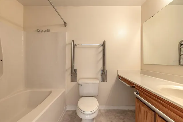 a bathroom with a granite countertop toilet a sink and bathtub