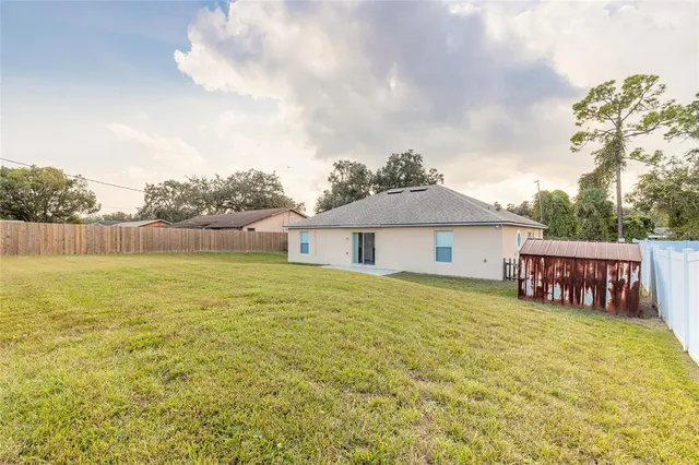 a view of a house with a yard and sitting area