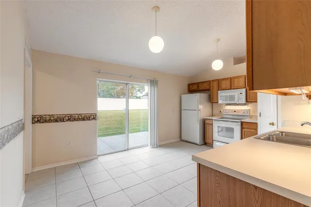 a kitchen that has a microwave a stove and a refrigerator
