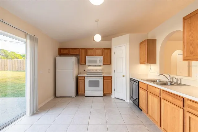 a kitchen with a refrigerator sink and stove