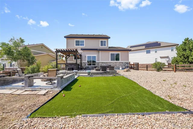 a view of a patio with couches table and chairs and potted plants