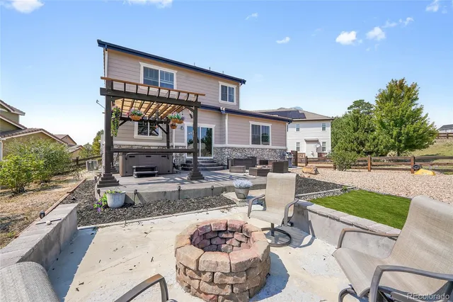 a front view of a house with garden and patio