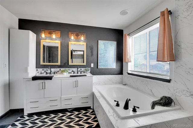 a bathroom with a tub and a window