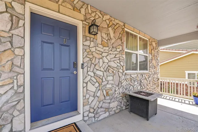 an aerial view of residential houses with outdoor space and ocean view