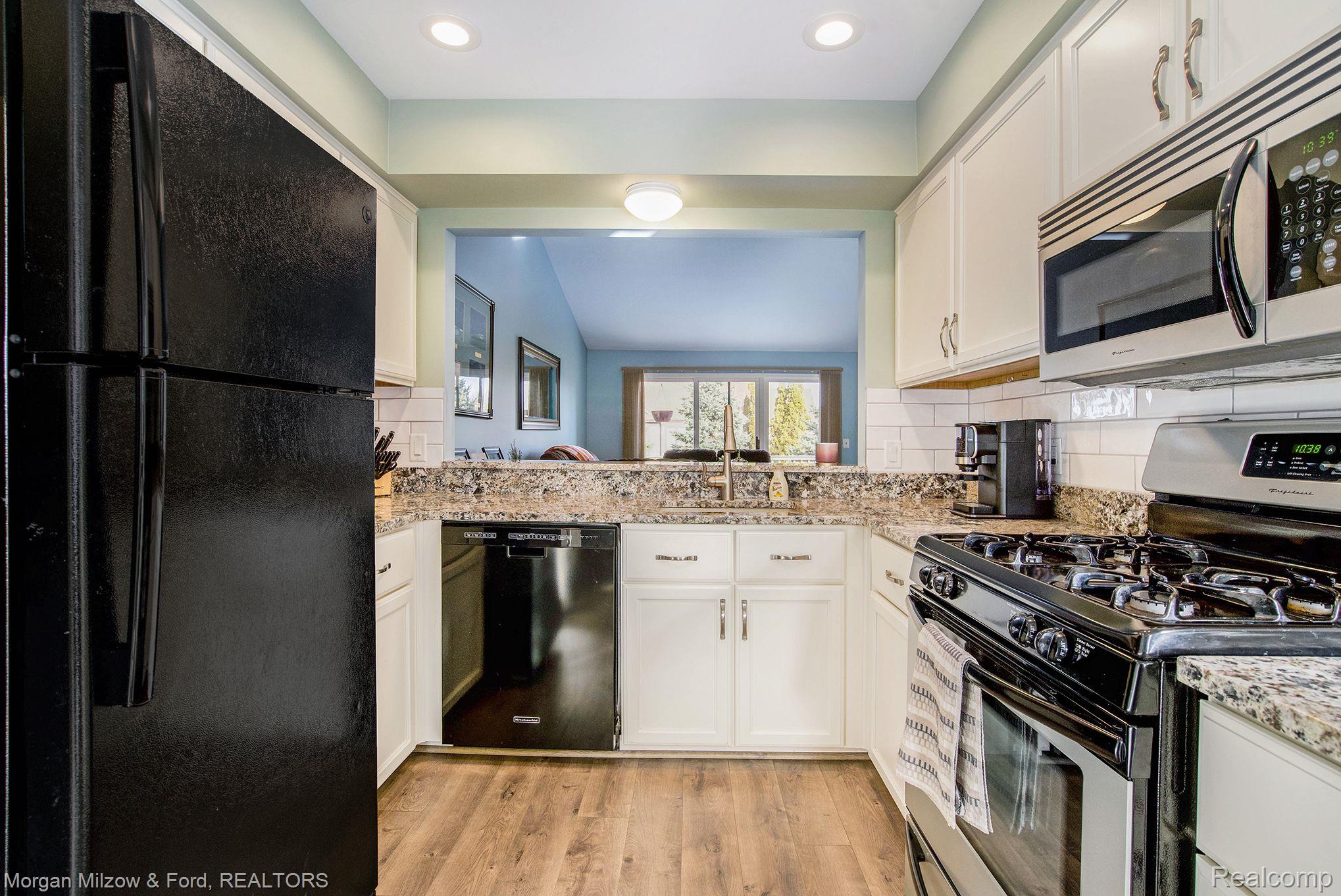 15475 Heather Ridge Trail Clinton Township, MI 48038 - Photo 7 of 24 Refaced kitchen cabinetry & granite countertops