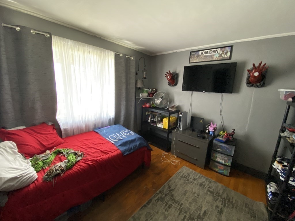 3 Chestnut Street Dudley, MA 01571 - Photo 8 of 20 a bedroom with a bed a couch and a flat tv screen