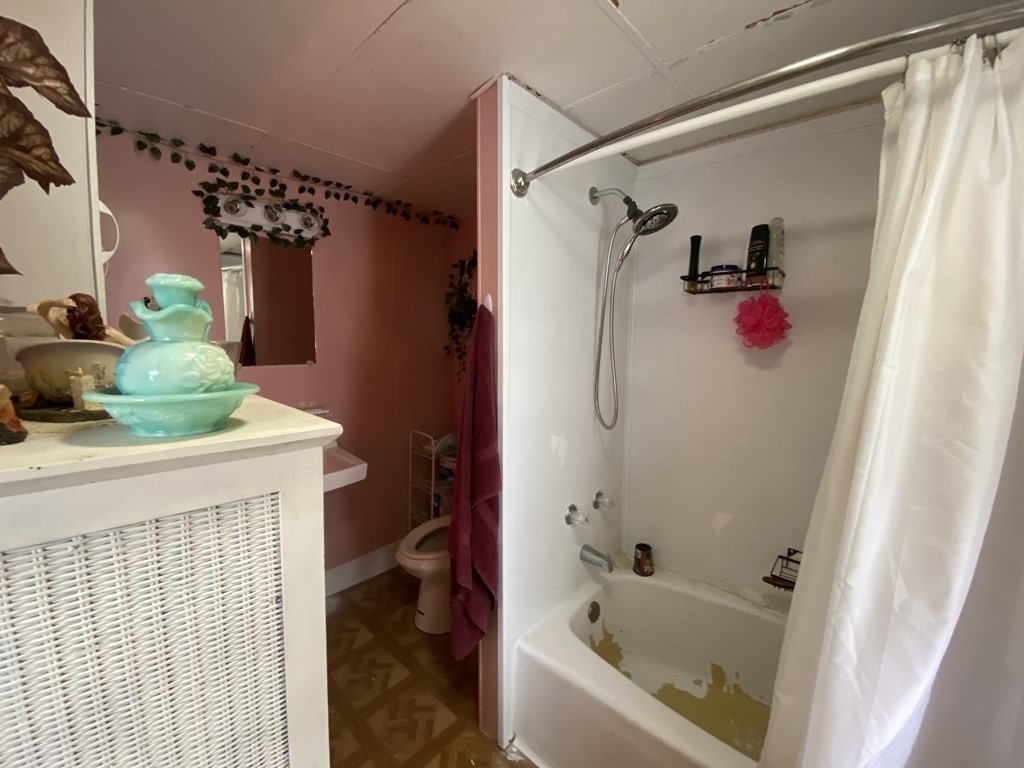 3 Chestnut Street Dudley, MA 01571 - Photo 10 of 20 a bathroom with a bathtub and shower