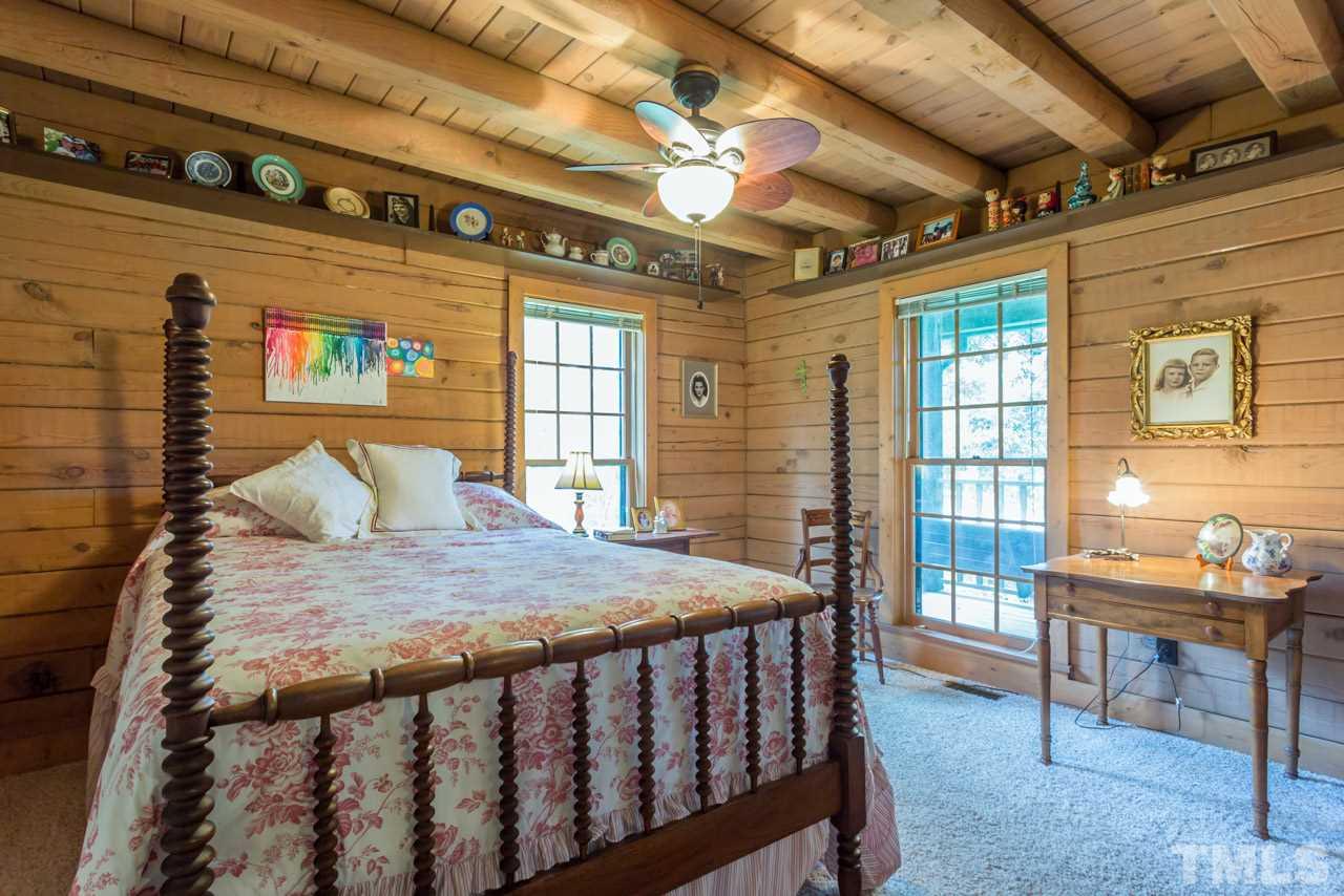 11816 Possum Track Road Raleigh, NC 27614 - Photo 12 of 25 a bedroom with a bed and wooden floor