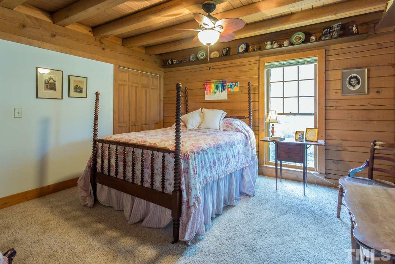 11816 Possum Track Road Raleigh, NC 27614 - Photo 13 of 25 a bed room with a bed and a chair