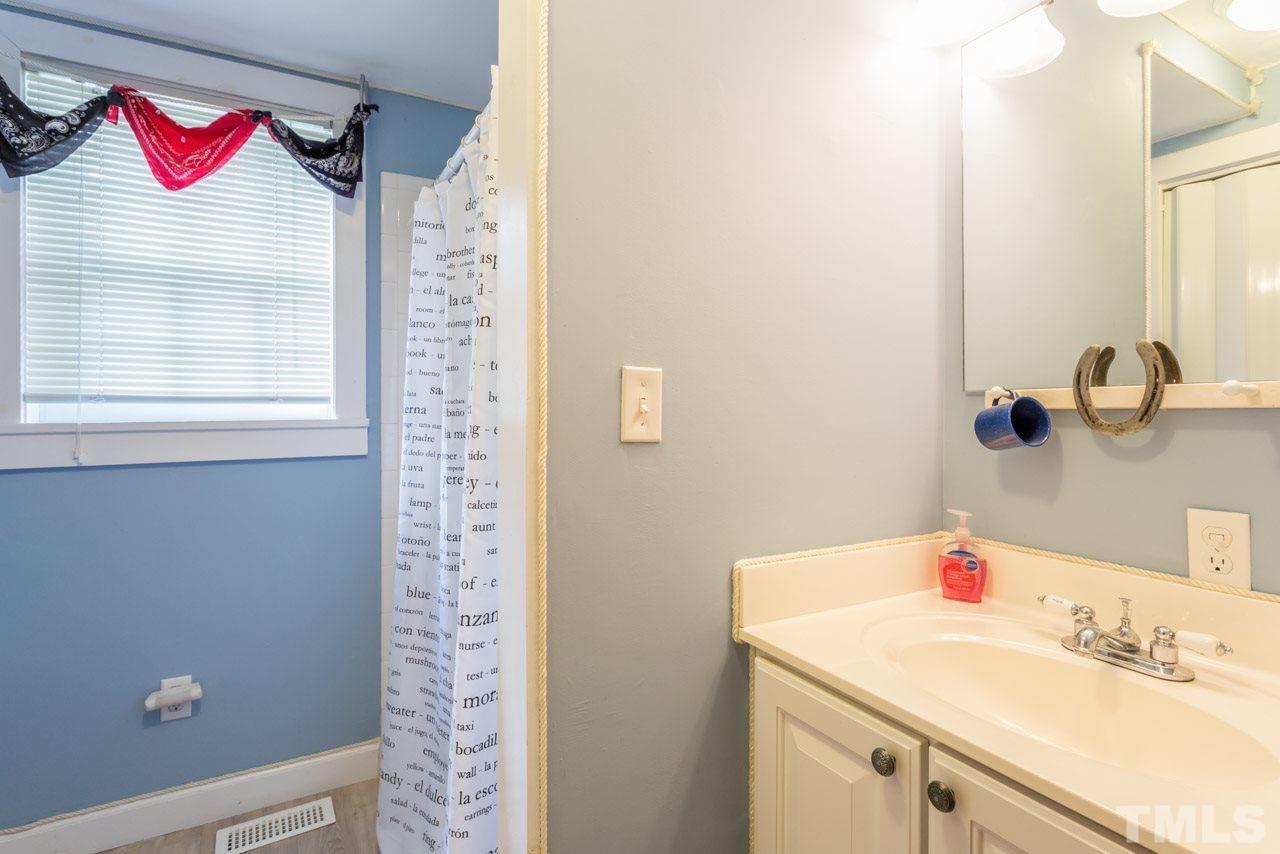 11816 Possum Track Road Raleigh, NC 27614 - Photo 15 of 25 a bathroom with a sink and a mirror