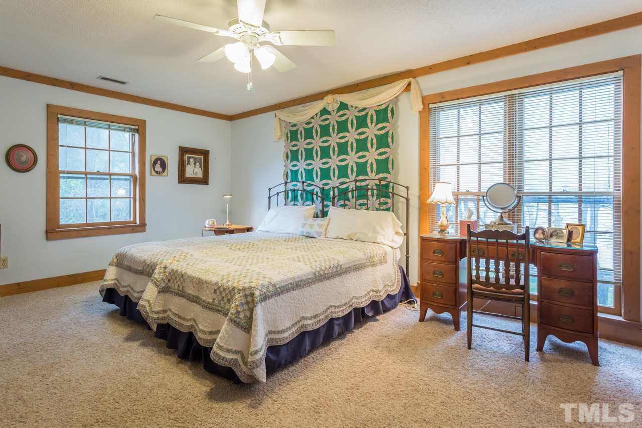 11816 Possum Track Road Raleigh, NC 27614 - Photo 16 of 25 a spacious bedroom with a bed and a large window
