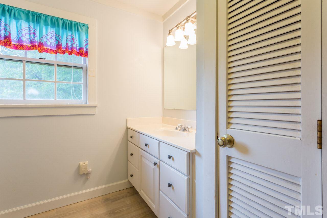 11816 Possum Track Road Raleigh, NC 27614 - Photo 20 of 25 a bathroom with a sink and a mirror