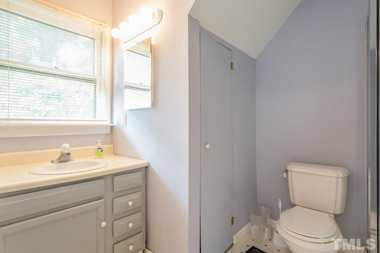 11816 Possum Track Road Raleigh, NC 27614 - Photo 24 of 25 a bathroom with a sink a toilet and a window