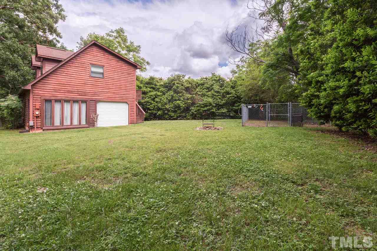 11816 Possum Track Road Raleigh, NC 27614 - Photo 5 of 25 a view of a yard in front of a house with plants and large tree