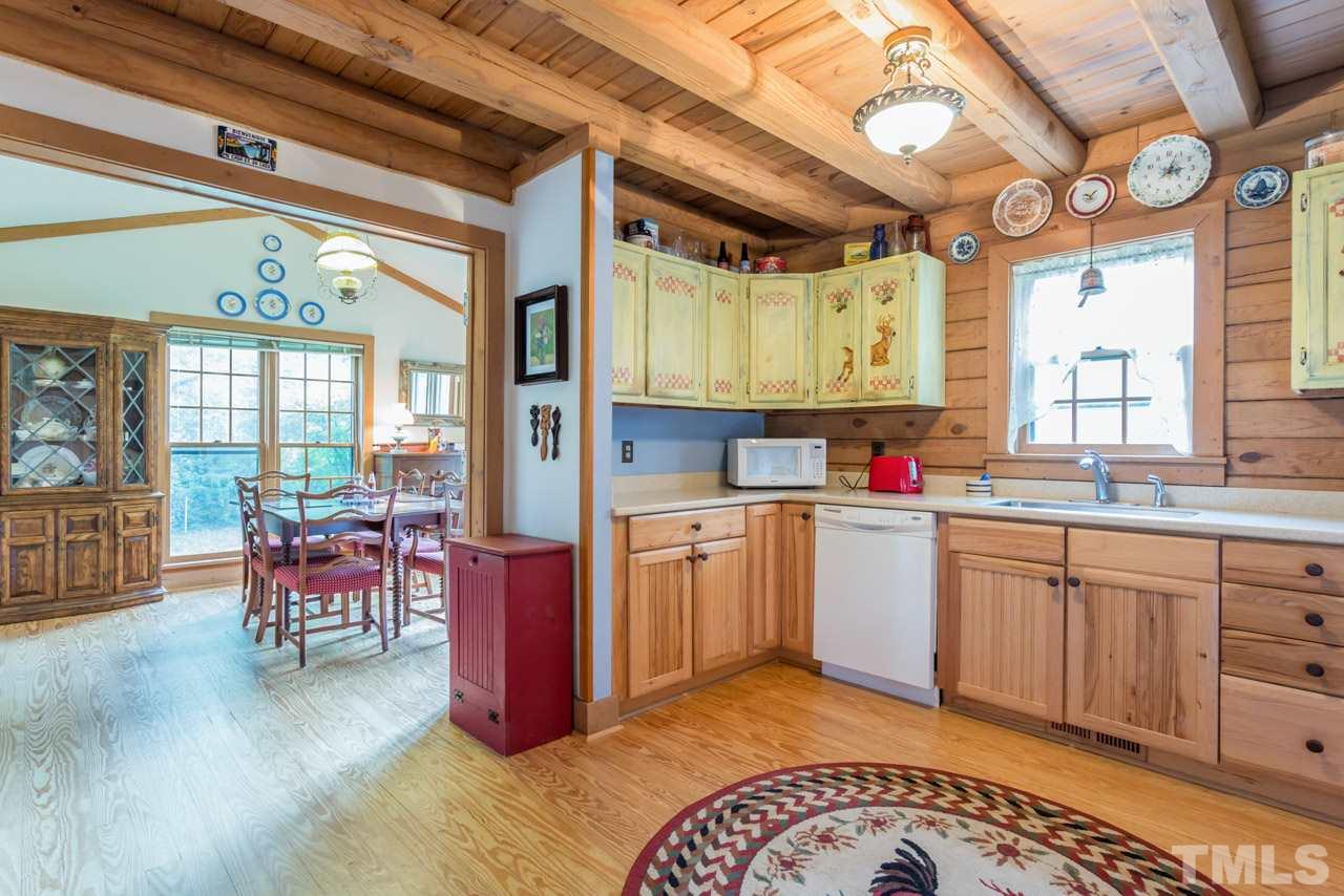 11816 Possum Track Road Raleigh, NC 27614 - Photo 10 of 25 a kitchen with a large window in it and kitchen island