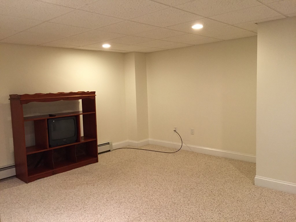 8 Autumn Woods Drive, Unit 8 Rutland, MA 01543 - Photo 12 of 16 a view of an empty room with a fireplace